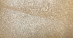 The product is a vintage automotive vinyl for 1987 GM vehicles. This original equipment manufacturer (OEM) new old stock (NOS) item was manufactured in the United States and comes in a quantity of 1 yard each. This original vinyl is a direct replacement for the interior seats of GM vehicles manufactured in 1987, offering a unique and authentic touch for car enthusiasts looking to restore or customize their classic vehicles. This authentic Original General Motors brown/beige vinyl is in the Sierra Pattern. 1 yard measures 36" x 55"